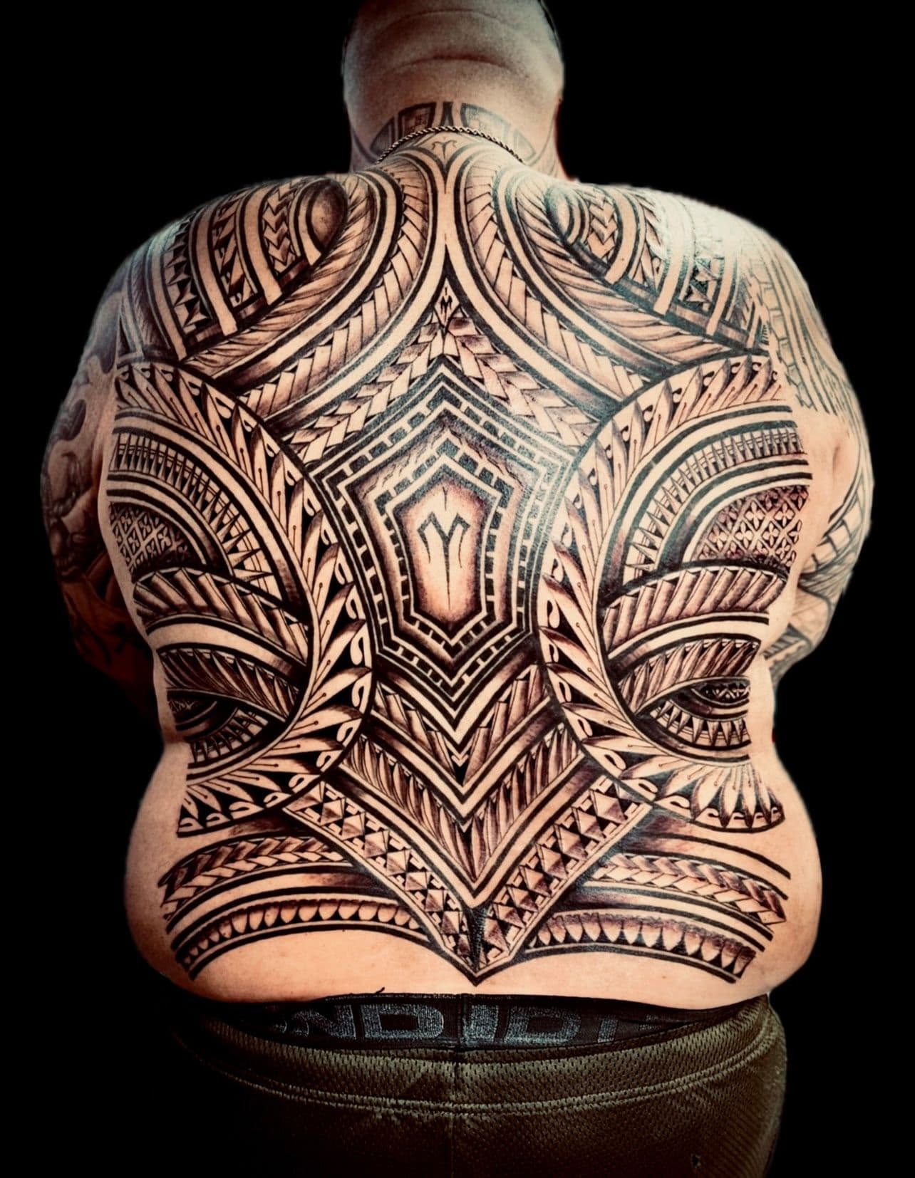 Tribal blackwork tattoo covering entire back
