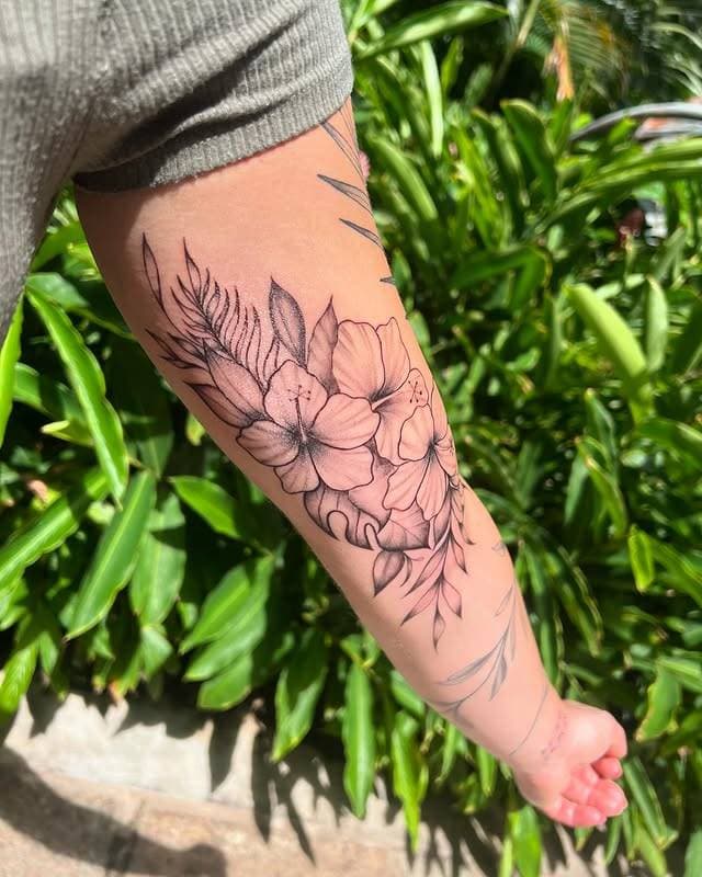 Black and grey botanical floral tattoo on forearm